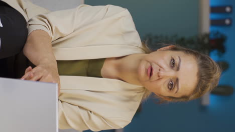Vertical-video-of-Home-office-worker-woman-looking-at-camera-depressed.